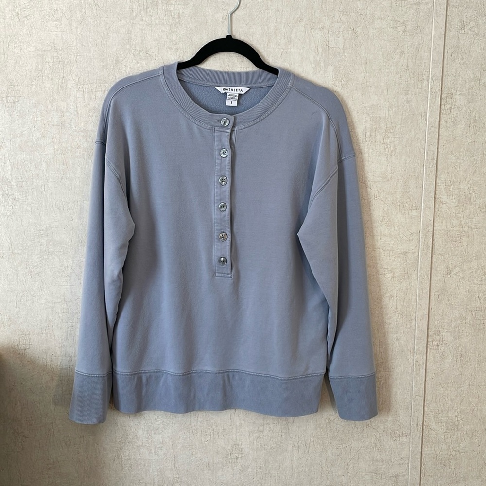 Athleta size small long sleeve pullover light blue top with buttons.